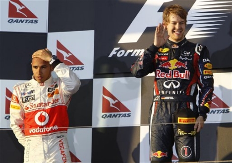<b>END OF AUSTRALIAN GP? Red Bull's Sebastian Vettel poses on the podium next to McLaren's Lewis Hamilton, after winning the 2011 Aus GP race. Unless Melbourne can fix it's finances F1 could be lost from Australia in the near future.