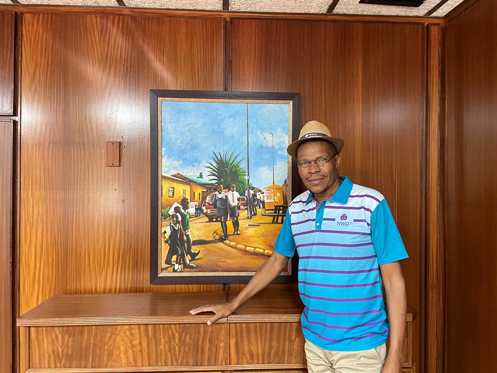 Outgoing North-West University vice-chancellor Professor Dan Kgwadi in front of one of his favourite paintings in his office on the Potchefstroom campus (James de Villiers, News24) 