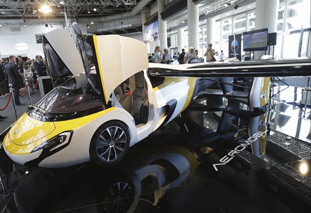 <b> IS IT A CAR? IS IT A PLANE? </b> AeroMobil display their latest prototype of a flying car in Monaco. <i> Image: AP / Claude Paris </i>
