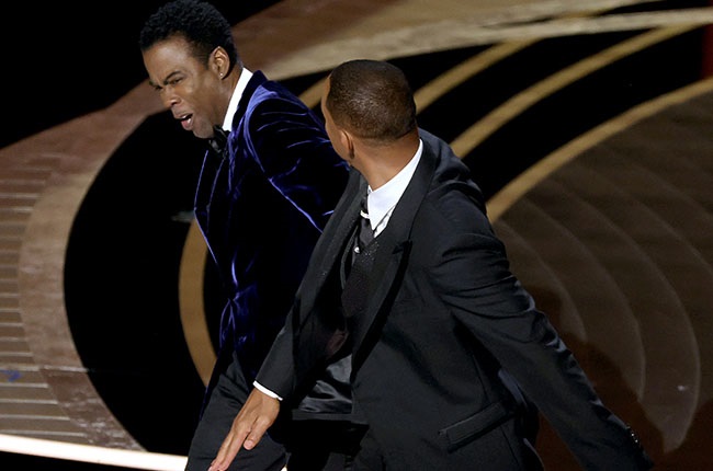Chris Rock and Will Smith are seen on stage during 