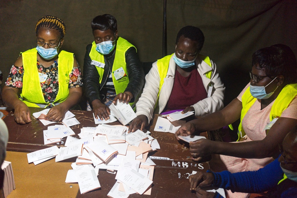 Election officials sort voting papers for ballot counting after a by-election at a polling station in Mbizo township, Kwekwe.