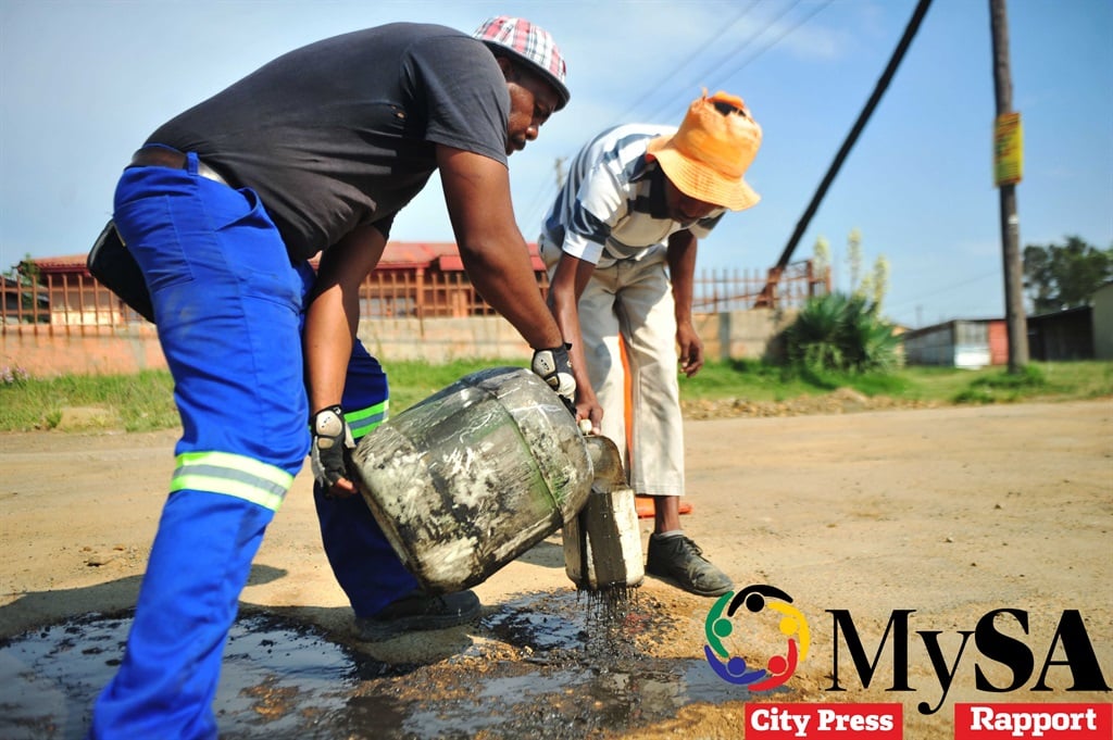 Sabata Tsotsotso works with 13 volunteers to fix the potholes in Matwabeng.