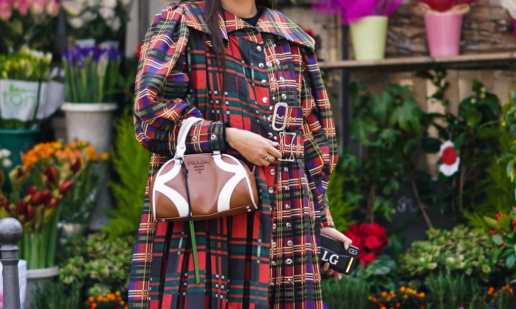  Leaf Greener wears sunglasses, a brown leather Prada bag, a red checked trench coat, black leather shoes, hair pins, outside Koche x Pucci, during Milan Fashion Week Fall/Winter 2020-2021 on February 20, 2020 in Milan, Italy. (Photo by Edward Berthelot/Getty Images)