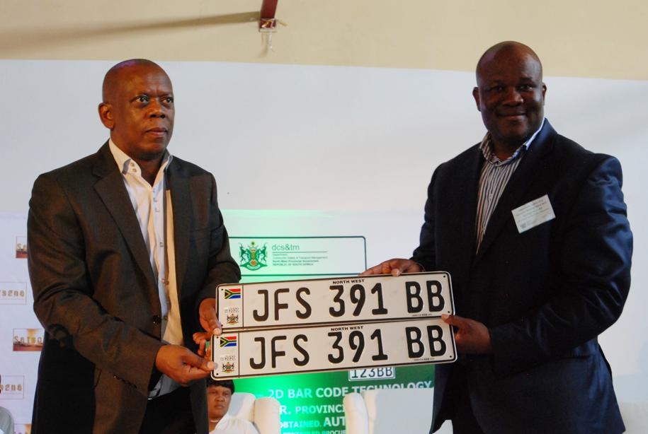 Bailey Mahlakoleng and community safety and transport MEC Gaoage Molapis with samples of the new North West registration plates. Photo by Samson Ratswana