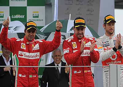 <b>BRAZILIAN LAURELS TO BUTTON:</b> Brazilian Felipe Massa (left), Fernando Alonso (centre) and Jenson Button celebrate on the  Sao Paulo podium. Button won, followed by Alonso and home-boy Massa. <i>Image: AFP</i>