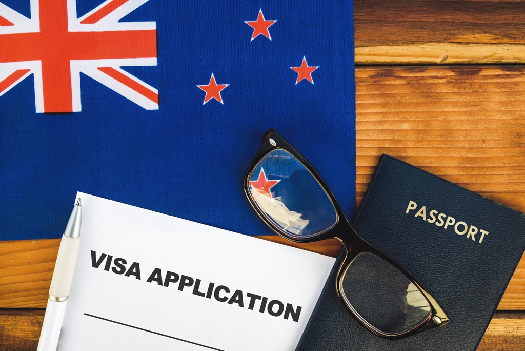 Flag of New Zealand , visa application form and passport on table