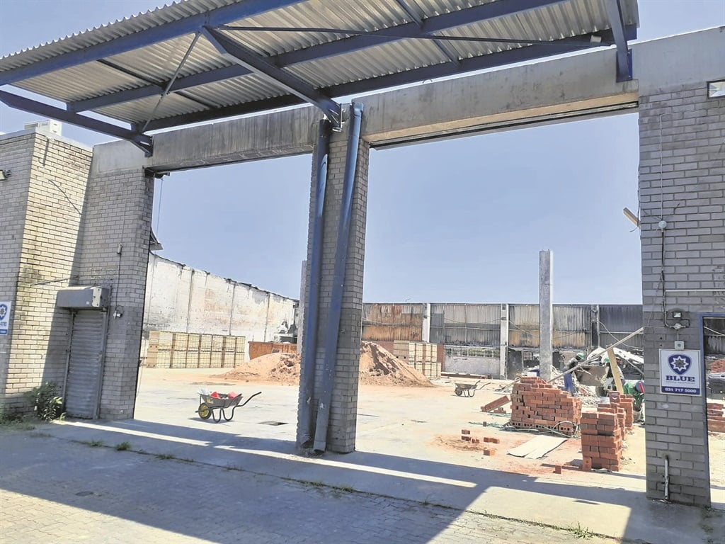Rebuilding has started at the two Bass and Tucker Construction factories that were torched to the ground during the July unrest.