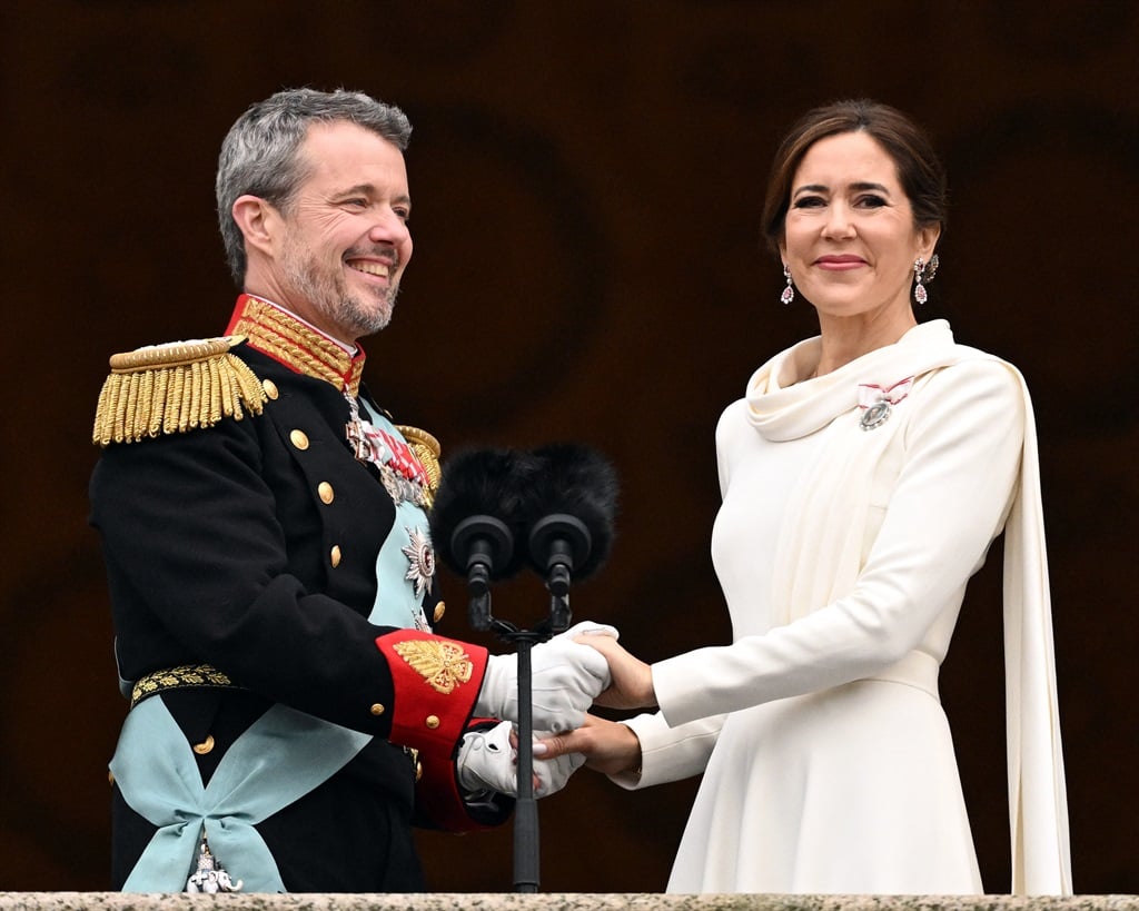 King Frederik X of Denmark and Queen Mary of Denmark hold hands as they stand on the balcony of Christiansborg Palace in Copenhagen, Denmark on 14 January 2024.