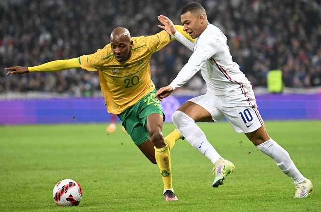 Kylian Mbappe (R) fights for the ball with Khuliso Mudau (L) during an international friendly match between France and South Africa at Pierre-Mauroy stadium in Villeneuve-d'Ascq on 29 March 2022. 