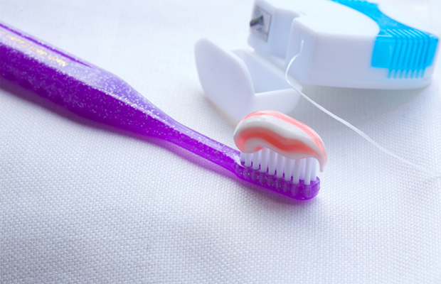 Close up of a toothbrush and floss