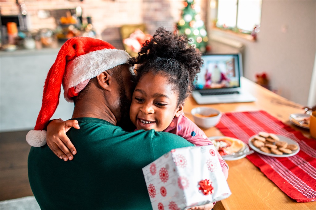 Close up of a father and daughter celebrating Christmas with Santa Claus on the Video Call