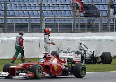 <b>INTO THE WALL:</b> Ferrari's Fernando Alonso passes Michael Schumacher and his wrecked Mercedes after the German crashed during the second practice session for the 2012 German GP at Hockenheim. <i>Image: AFP</i>
