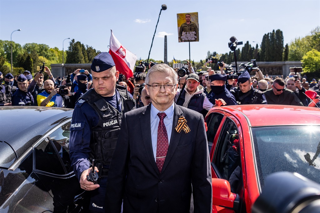 Russia's Ambassador to Poland Sergey Andreev is seen surrounded by journalists and Ukrainian protesters as he leaves after his attempt of laying a wreath at the Soviet soldier war mausoleum in Warsaw on May 9, 2023, to mark the 78th anniversary of the victory over Nazism and the end of the World War II in Europe.
