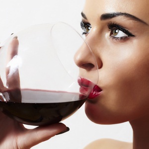 Woman drinking red wine from Shutterstock