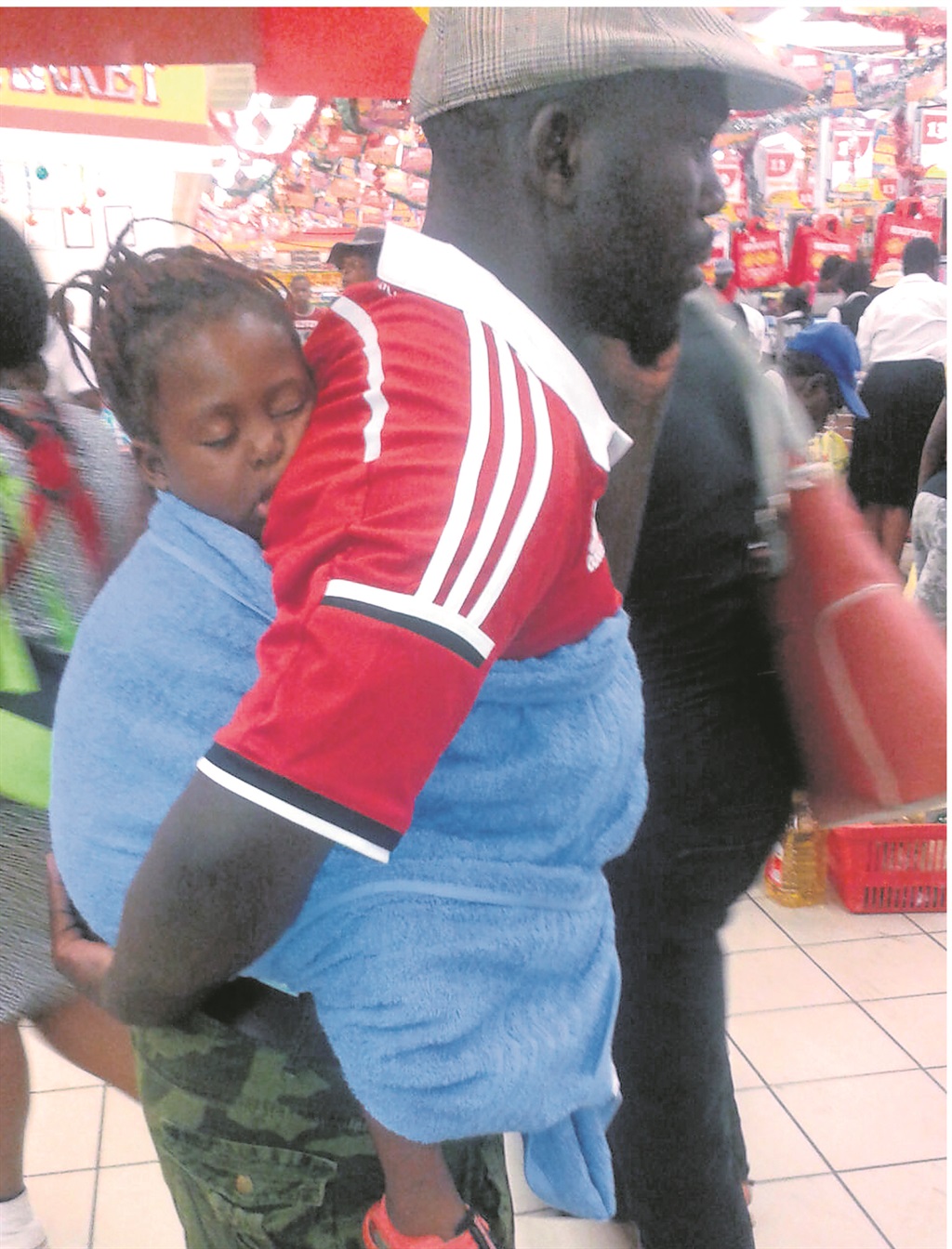 Sandani Muremela surprised people when he was seen carrying his daughter on his back while shopping in Makhado.              Photo by Quibell Rantswana 