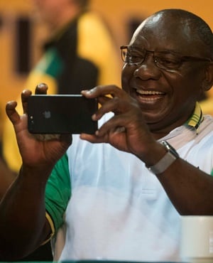 New president of the ANC Cyril Ramaphosa snaps pictures during the announcement of new party leadership at the ANC national conference at the Nasrec Expo Centre. (Alet Pretorius, Gallo Images)
