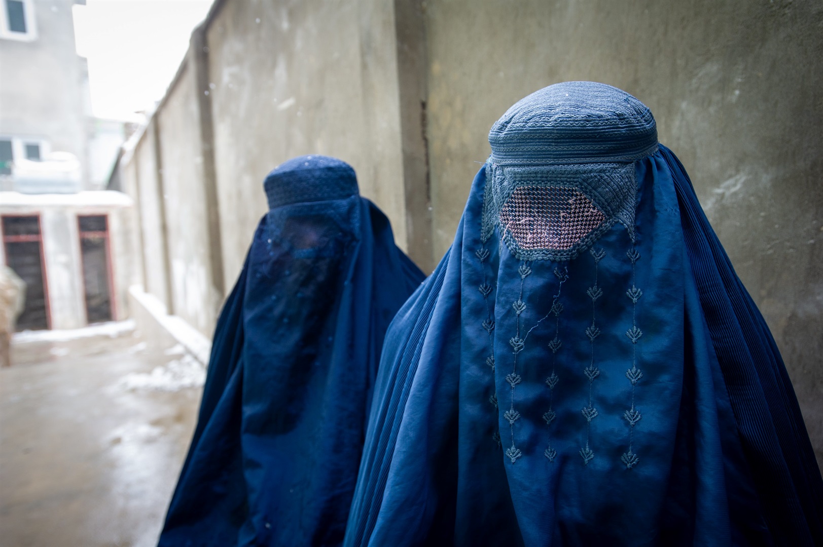 Two women wearing burqas in Afghanistan.