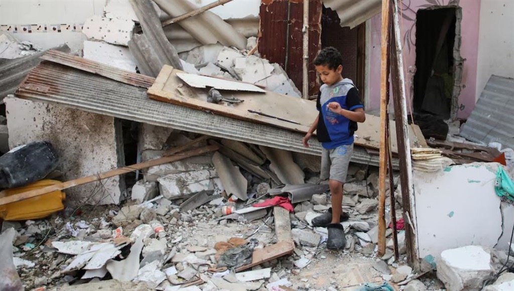A Palestinian boy inspects the site of an Israeli strike on a house, amid the ongoing conflict between Israel and the Palestinian Islamist group Hamas, in Rafah, in the southern Gaza Strip, May 1, 2024. REUTERS