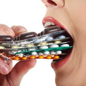 Ill woman with pills from Shutterstock