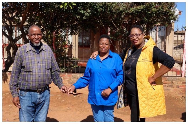 Thabisile and Prudence with their father, Thomas Buthelezi at the very same spot that Thabisile was hit by a car that left her hemiplegic for life, 38 years later.
