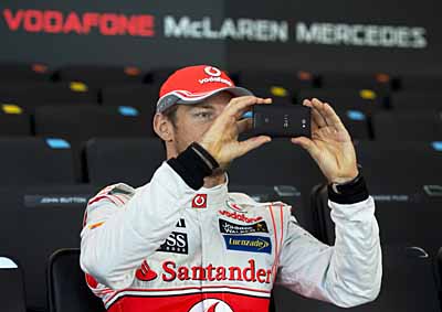 <b>TOO GOOD TO MISS:</b> McLaren driver Jenson Button makes his own personal record at the launch of McLaren's 2013 F1 race cars. <i>Image: AFP</i>