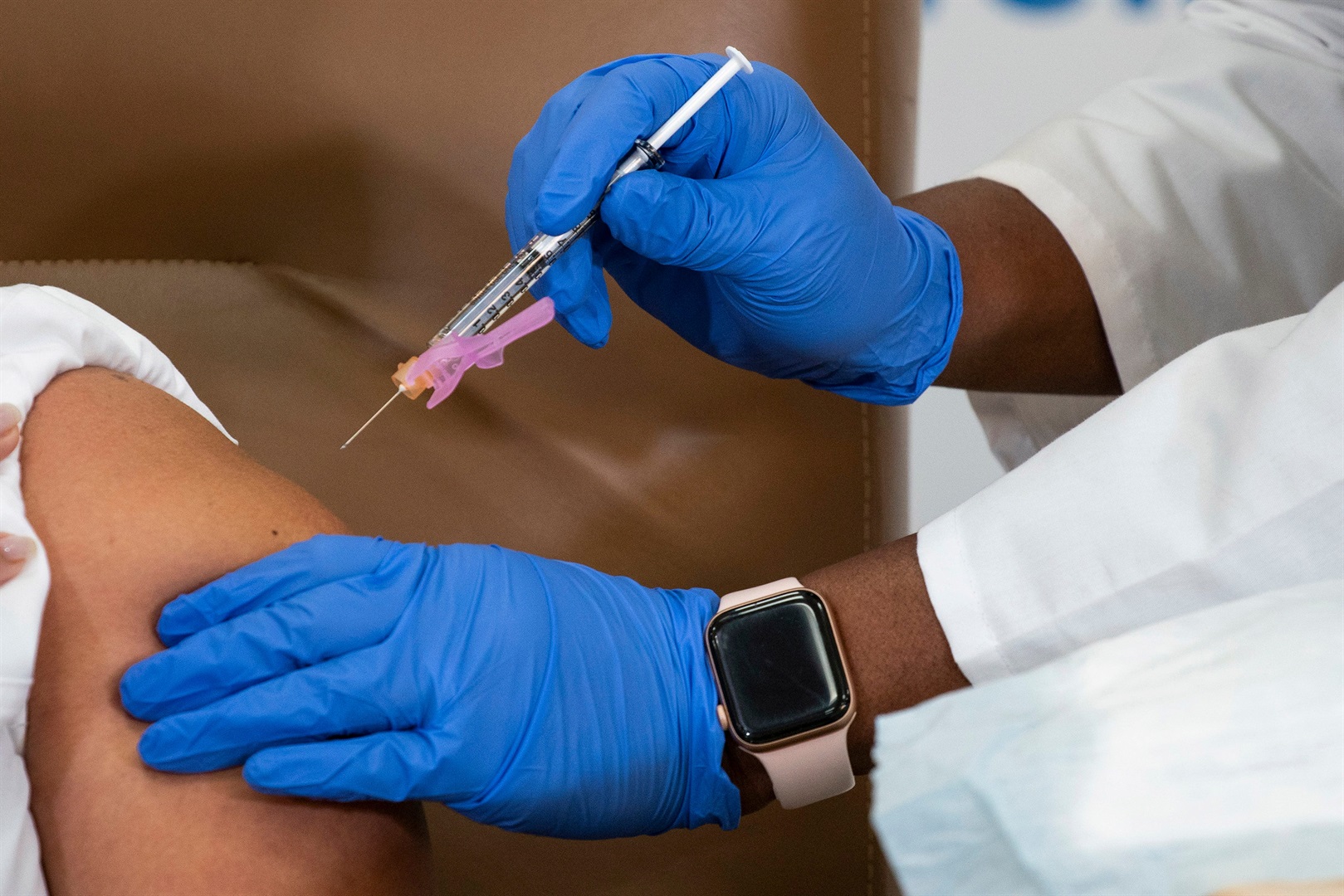 A nurse receives a Covid-19 vaccine.
