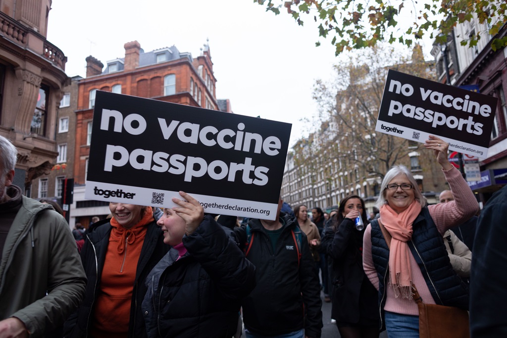 Protestors seen holding placards that say No vaccine passports during the demonstration.