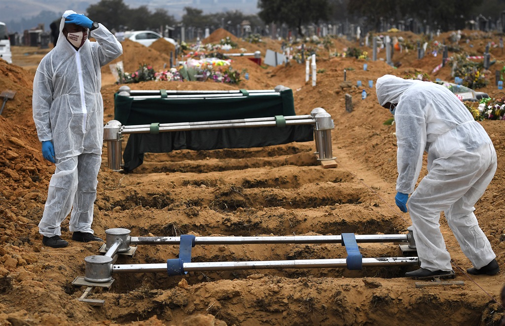 Funeral parlour staff preparing a grave for a Covid-19-related death at Waterval Cemetery in Chloorkop, Johannesburg.