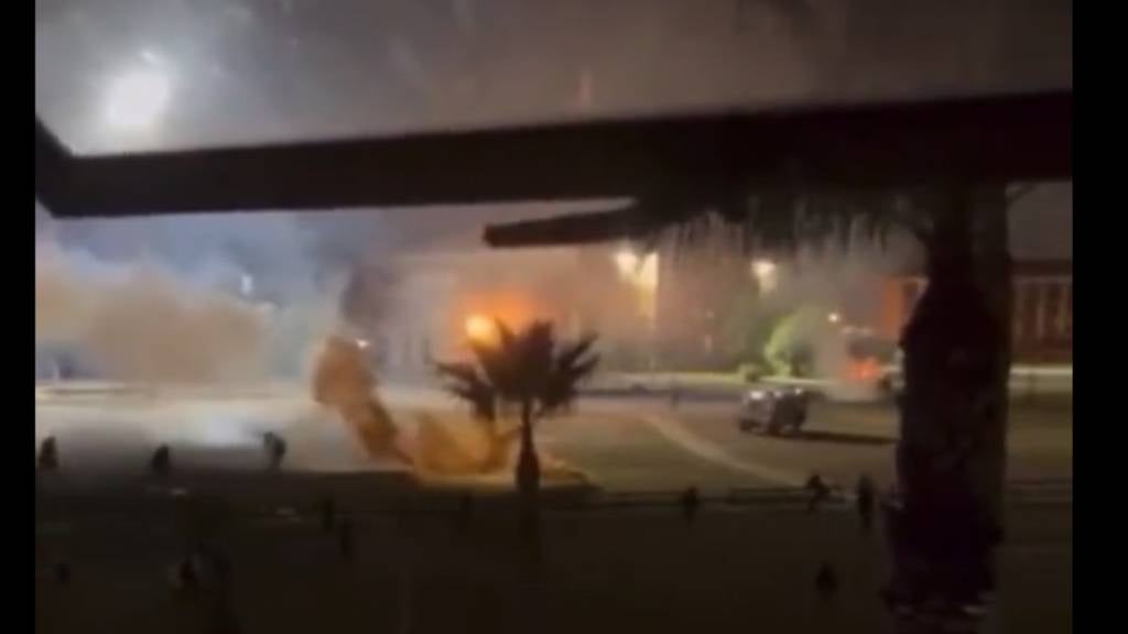 Blurry photo showing fires and rubble strewn during protests