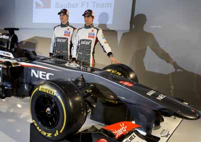 <b>SAUBER SHOWS 2013 ASSETS:</b> Sauber F1's Nico Hulkenberg (left) and Esteban Gutierrez with a C32-Ferrari race car they'll drive in the 2013 Formula 1 season. The car and drivers were shown in Switzerland on Feb 2 2013. <i>Image: AFP</i>