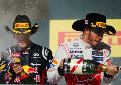 <b>CELEBRATORY CHAMPAGNE:</b> Lewis Hamilton and Sebastian Vettel celebrate podium finishes after the U.S. Grand Prix.