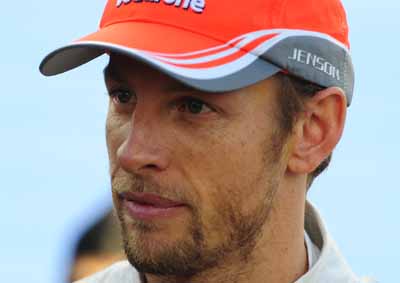 <b>WAVING FINGERS:</b> McLaren's Jenson Button has voiced his disappointment in team mate Sergio Perez for being "too aggressive" in the 2013 Bahrain GP on Sunday, April 21. <I>Image: AFP</I>