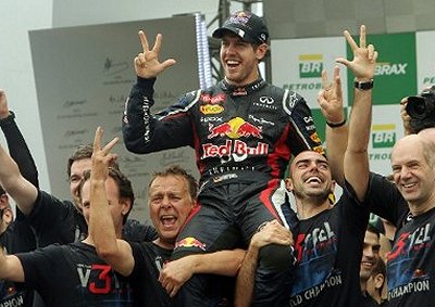 <b>RED BULL ON A HIGH:</b> Sebastian Vettel celebrates his third consecutive World title with his Red Bull team mates at the Interlagos circuit, Brazil. 