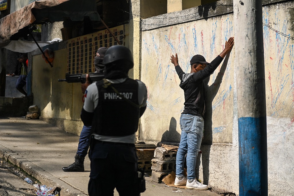 A man is under arrest by Haitian police in the Turgeau commune of Port-au-Prince, Haiti, during gang-related violence on 24 April, 2023. 