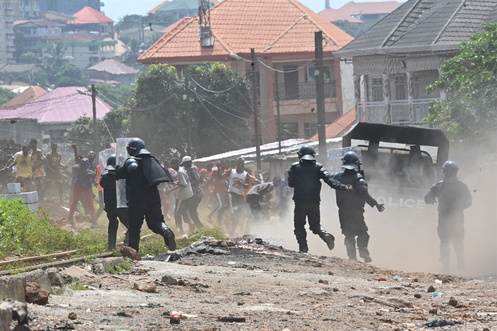 Riot police run to disperse protestors after the outlawed opposition group, The National Front for the Defence of the Constitution (FNDC), called for protests against the ruling Junta in Conakry on October 20,2022.