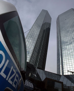 A police car stands in front of the Deutsche Bank headquarters in Frankfurt, central Germany. (Alex Domanski, dapd/AP)