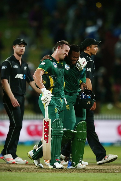 AB de Villiers of South Africa celebrates with teammate Andile Phehlukwayo after winning the First One Day International match between New Zealand and South Africa at Seddon Park on February 19, 2017 in Hamilton, New Zealand.