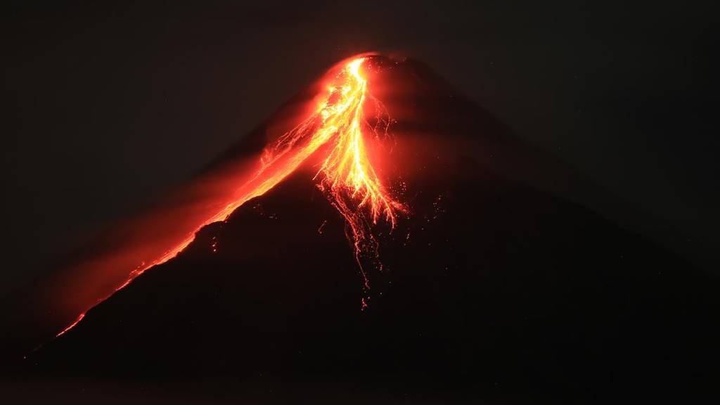 Mount Mayon spews lava during an eruption near Leg