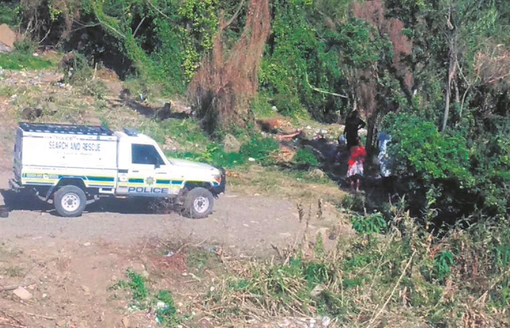 Police and family members at the scene where Fanizana Myeni’s body was found.                                            Photo by Mbali Dlungwana 