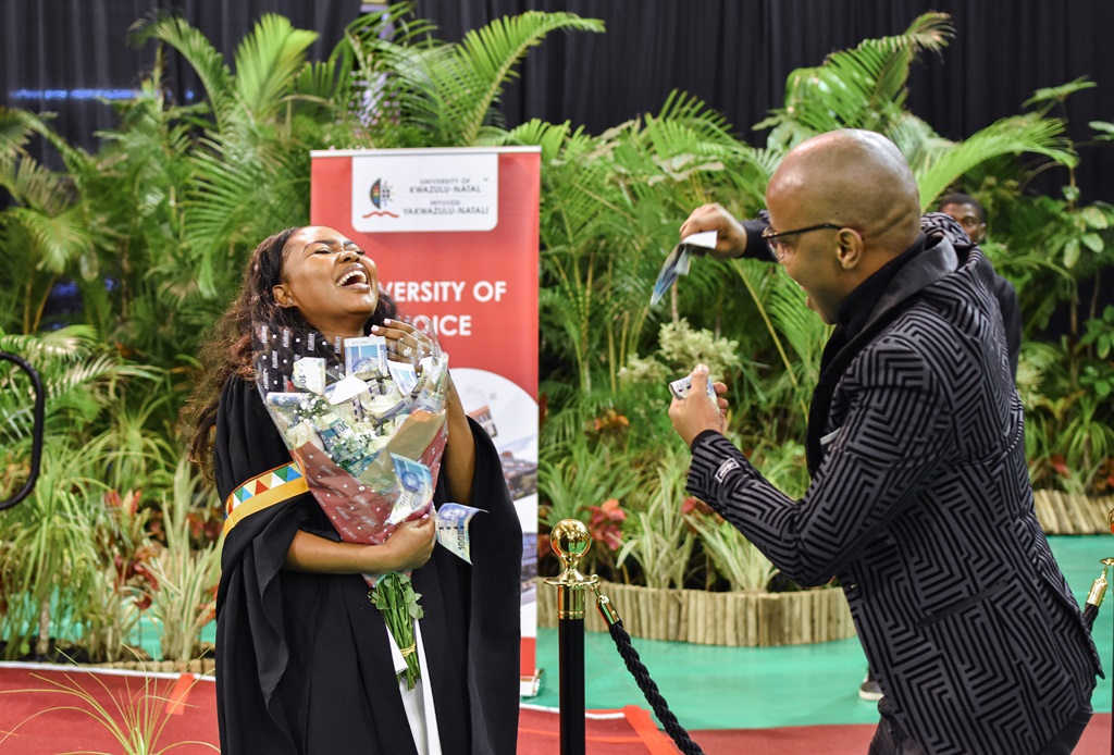 Zamela Malinga celebrating with her husband, Dr Sibongiseni Malinga on stage. 