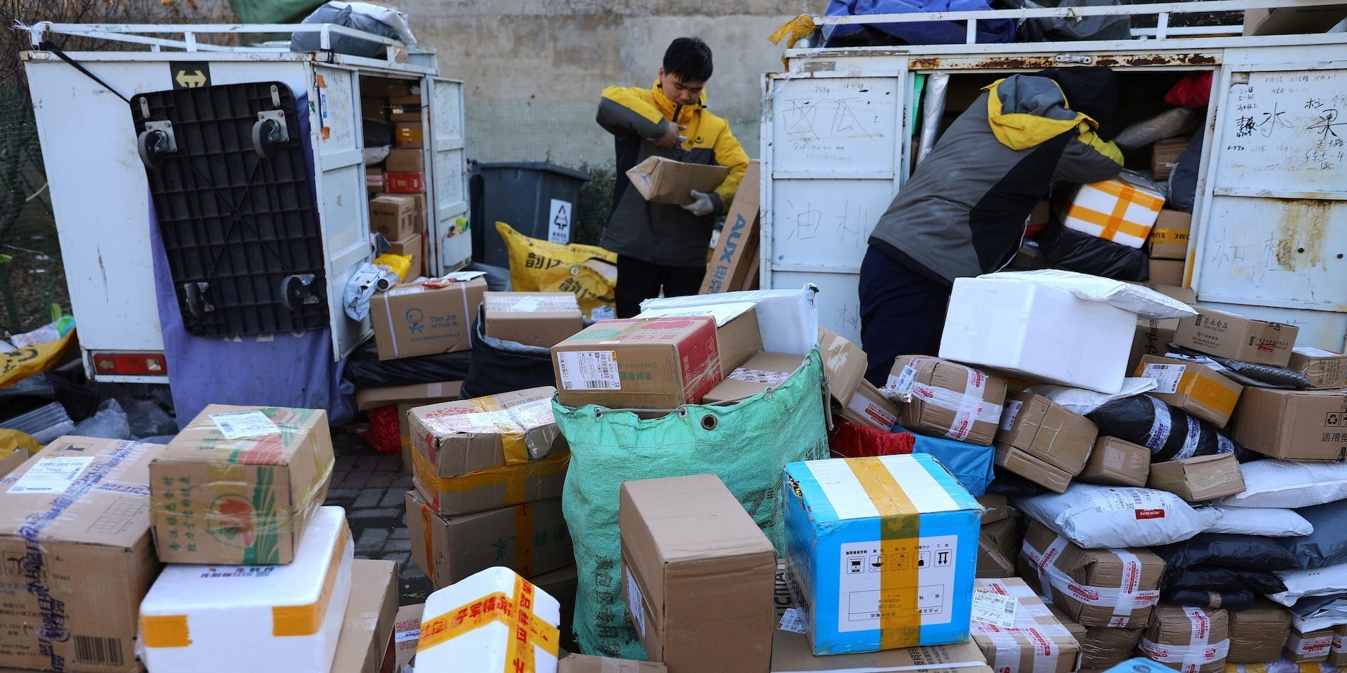 Delivery workers sort parcels at a makeshift logistics station in Beijing, China. REUTERS/Tingshu Wang