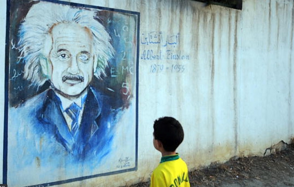 A wall showing a graffiti painting of Albert Einstein.