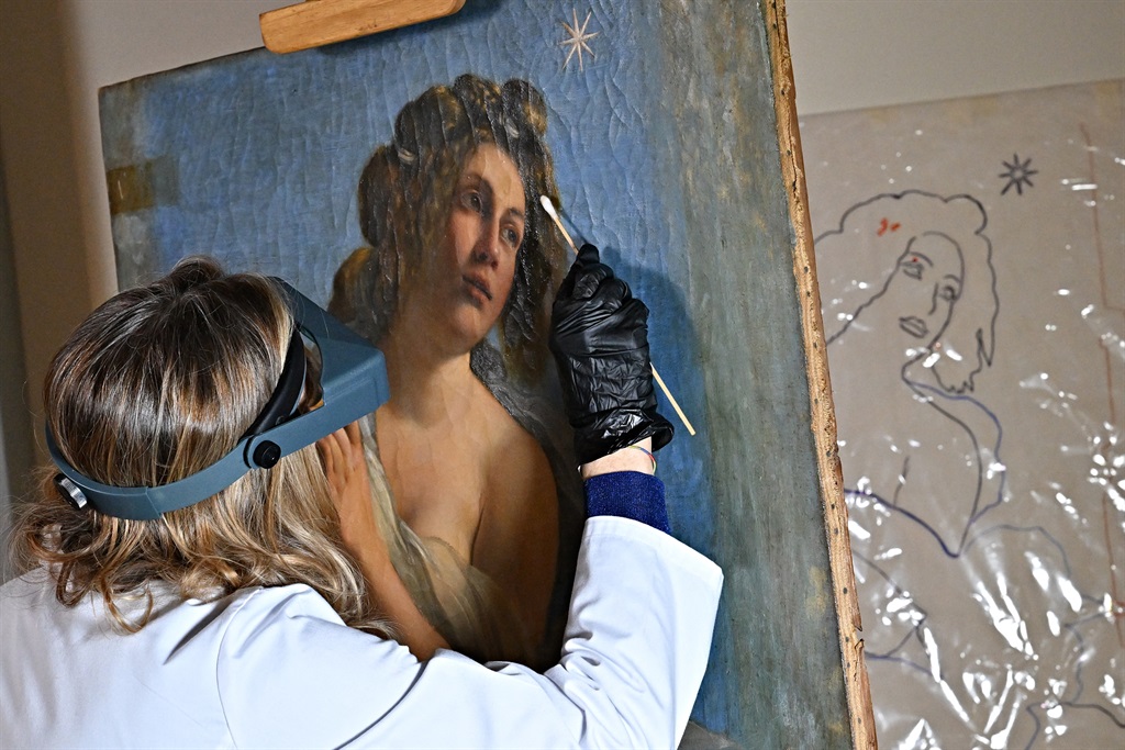 US conservator Elizabeth Wicks, works on a paintin