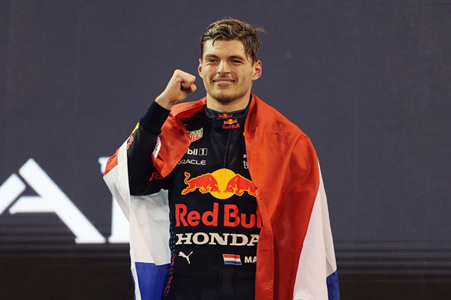 Race winner and 2021 F1 World Drivers Champion Max Verstappen of Netherlands and Red Bull Racing celebrates on the podium during the F1 Grand Prix of Abu Dhabi at Yas Marina Circuit on December 12, 2021 in Abu Dhabi, United Arab Emirates. 