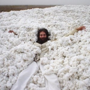 Richard Ziff, CEO of Of The Earth, an all natural clothing company, laying on 1,000 tons of OCIA Certified Organic Cotton.