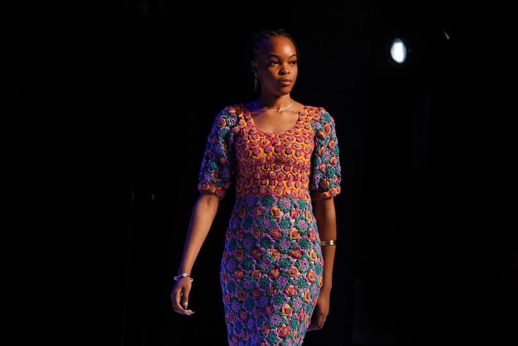 A model is seen wearing a Lorang M Africa design. The design is made of Covid-19 vaccine lids 