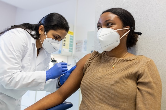 Young woman receiving a vaccine shot against a virus. (Getty Images)