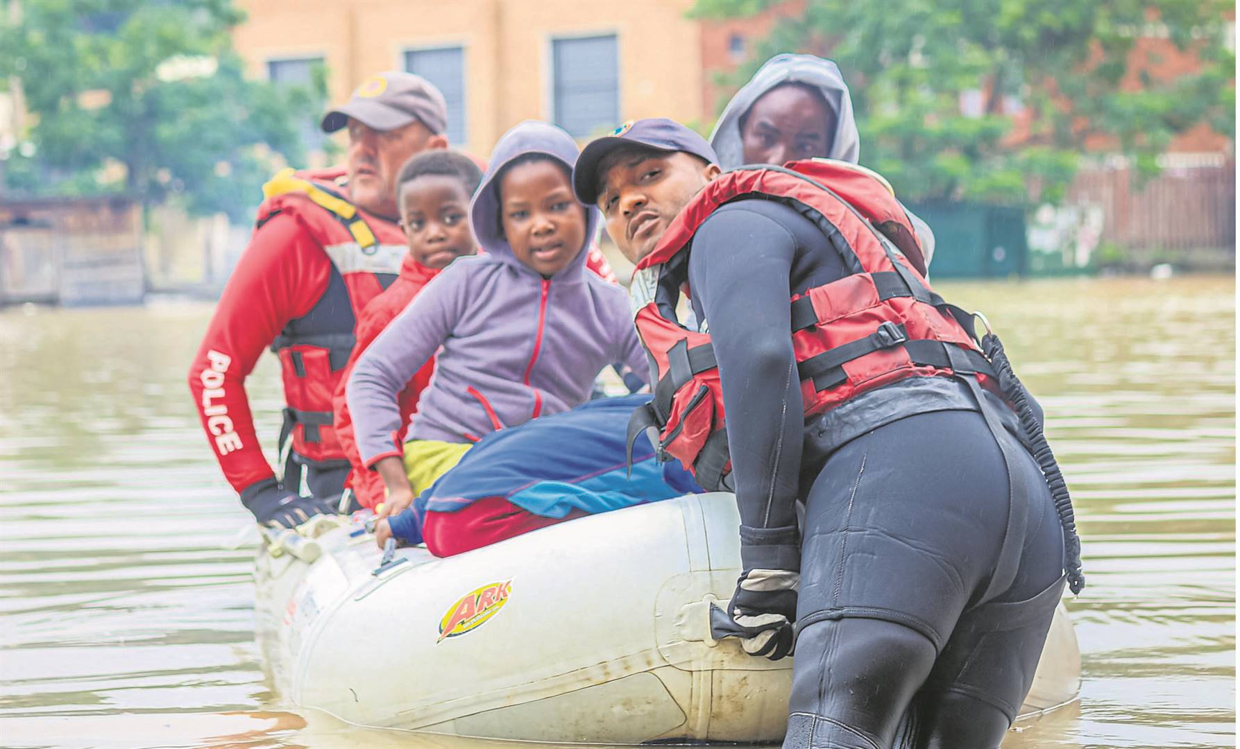 ABOVE: K-9 Search and rescue from Pietermaritzburg and Ladysmith using rubber boats to evacuate people from Alexander and Forbes Street, yesterday morning. The lower parts of Ladysmith were flooded after the Klip River burst its banks on Sunday night. Pictured are Pietermaritzburg Search and Rescue team Sergeant Jesse Mare (front) and Warrant officer Karl Gous escorting children who were stuck in a flat in the Ladysmith CBD. PHOTO: Claudine Senekal (Ladysmith Herald)