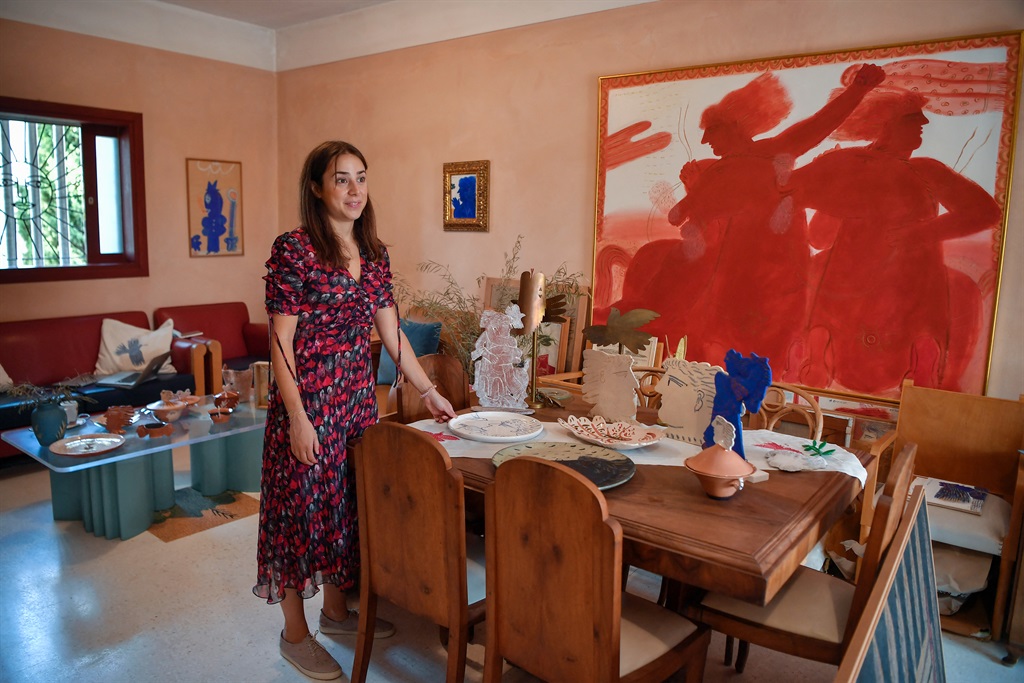 Viktoria Fassianou, daughter of Greek contemporary artist Alekos Fassianos, stands next to ceramics, artworks and furnitures created by her father in his house in Athens, on September 29, 2021, prior to the opening in the fall of 2022 of a museum in his name. (Louisa GOULIAMAKI / AFP)


