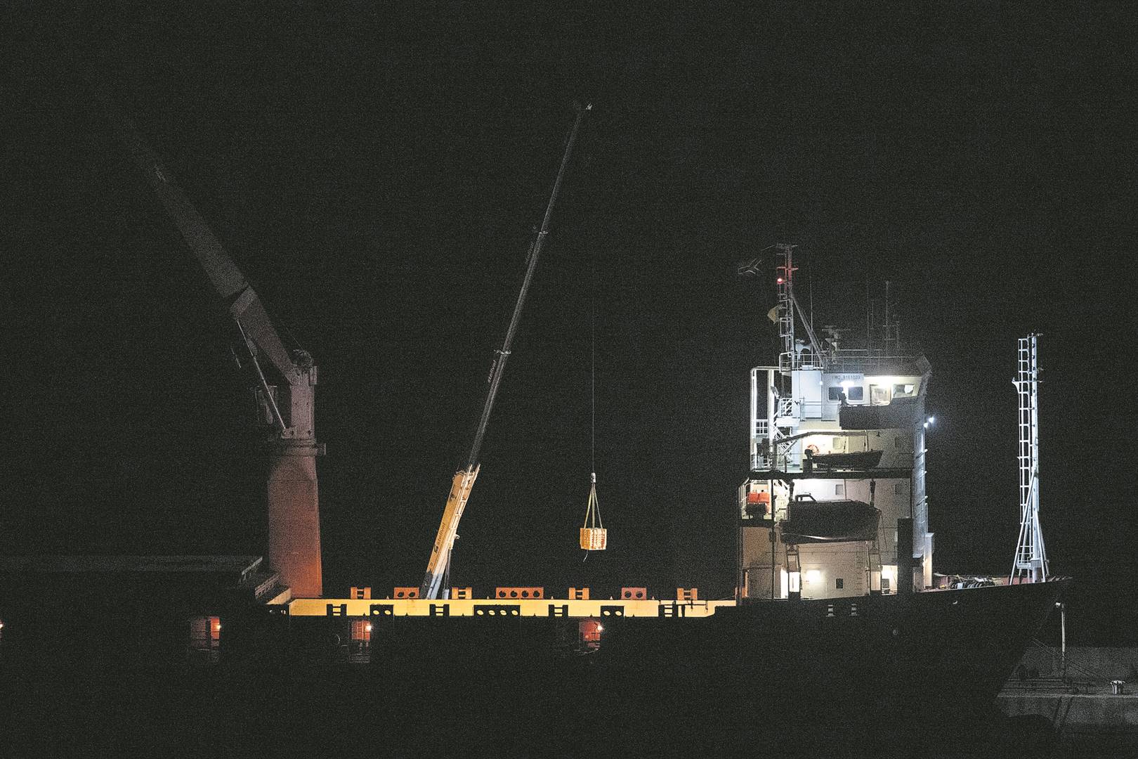 Cargo being offloaded from the Lady R under cover of darkness.